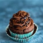 Vegan chocolate cupcake topped with ganache frosting and chocolate sauce