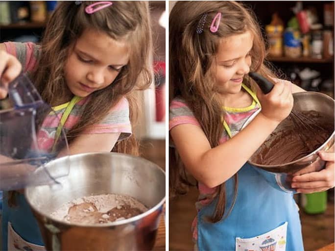 Child stirring cupcake batter in a bowl
