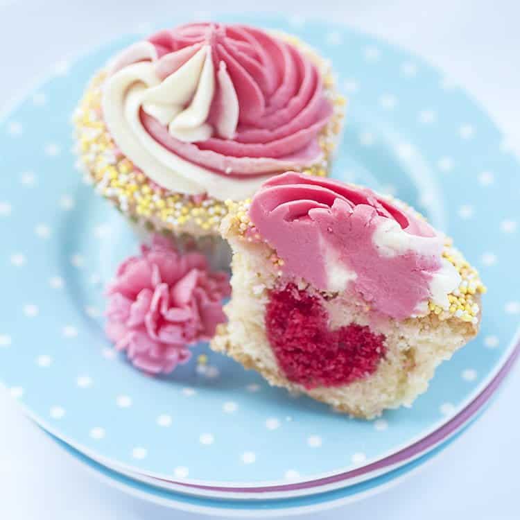 These cute raspberry and lemon swirl cupcakes hide a sweet surprise – a pink heart baked into the batter. Perfect for Valentine's day.