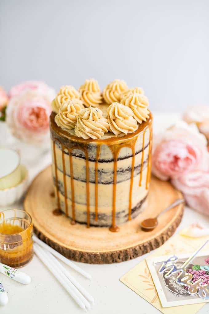 Chocolate and Caramel layer cake with caramel drip on wood plate
