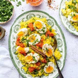 Kedgeree with smoked haddock and boiled eggs served in a platter with curried tomato sauce
