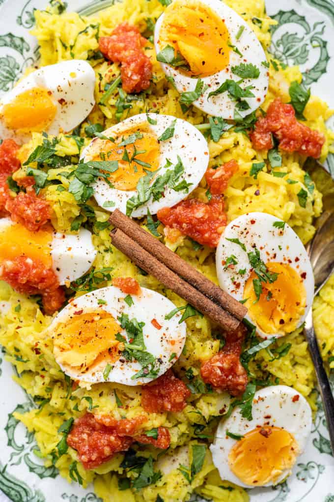 Close up on a platter of Smoked Haddock Kedgeree with boiled eggs and tomato sauce