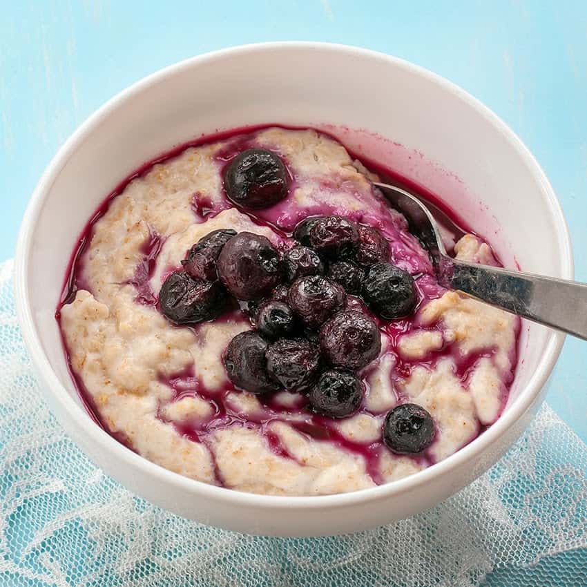 Close up on a bowl of vegan porridge with blueberries