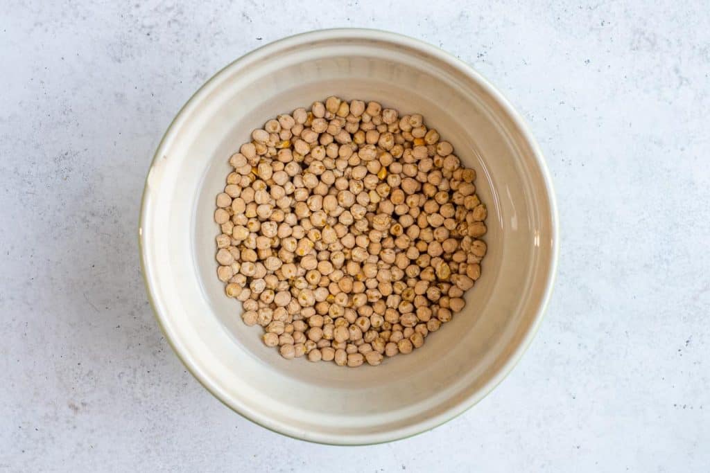 Soaking dry chickpeas in water to make falafel