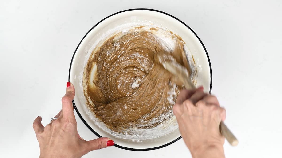mixing gingerbread dough in a bowl