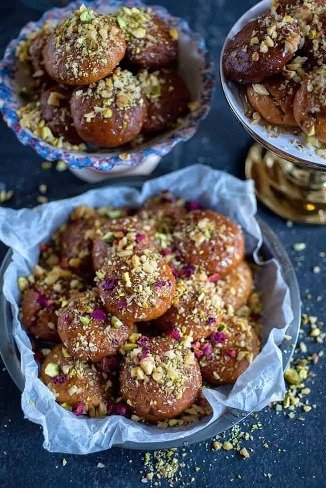 Greek Melomakarona topped with chopped walnuts and pistachios