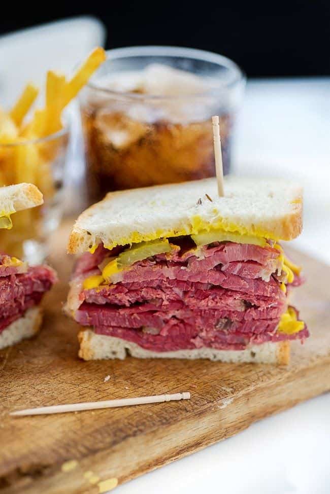 Salt beef sandwich with pickles and mustard