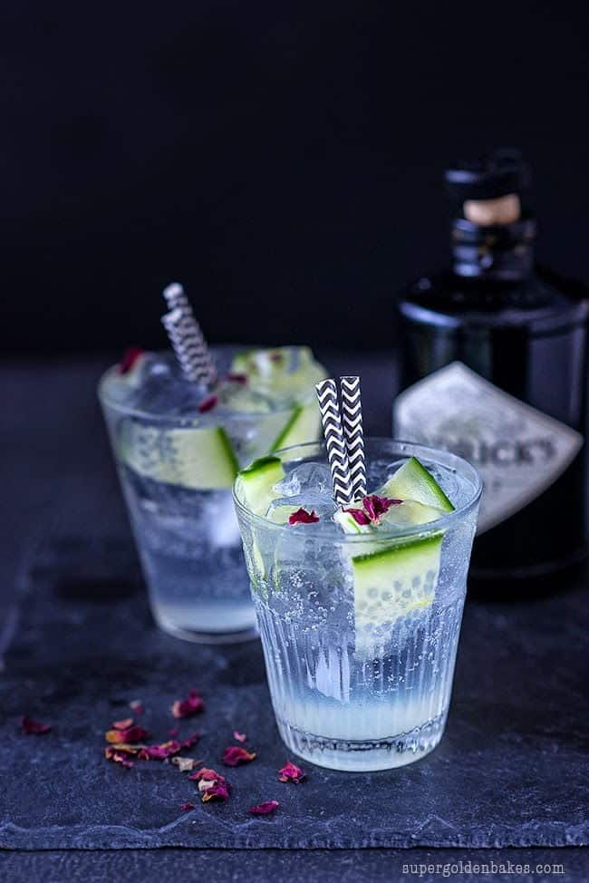 Two glasses of gin and tonic with cucumber slices