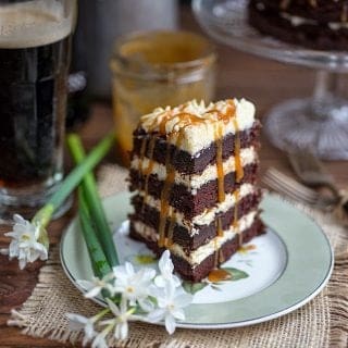 Slice of Guiness cake on a plate drizzled with caramel