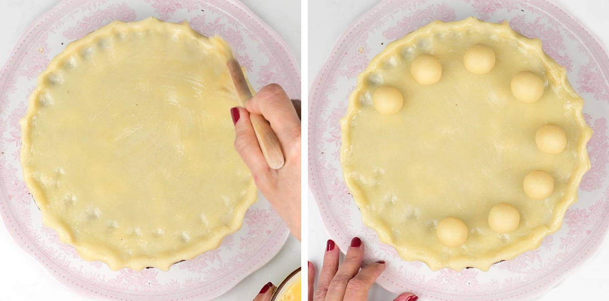 Brushing marzipan on top of Simnel cake with egg wash and decorating with marzipan balls