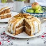 This moist apple cake packed with fragrant spices is filled with whipped mascarpone frosting and topped with toffee sauce.
