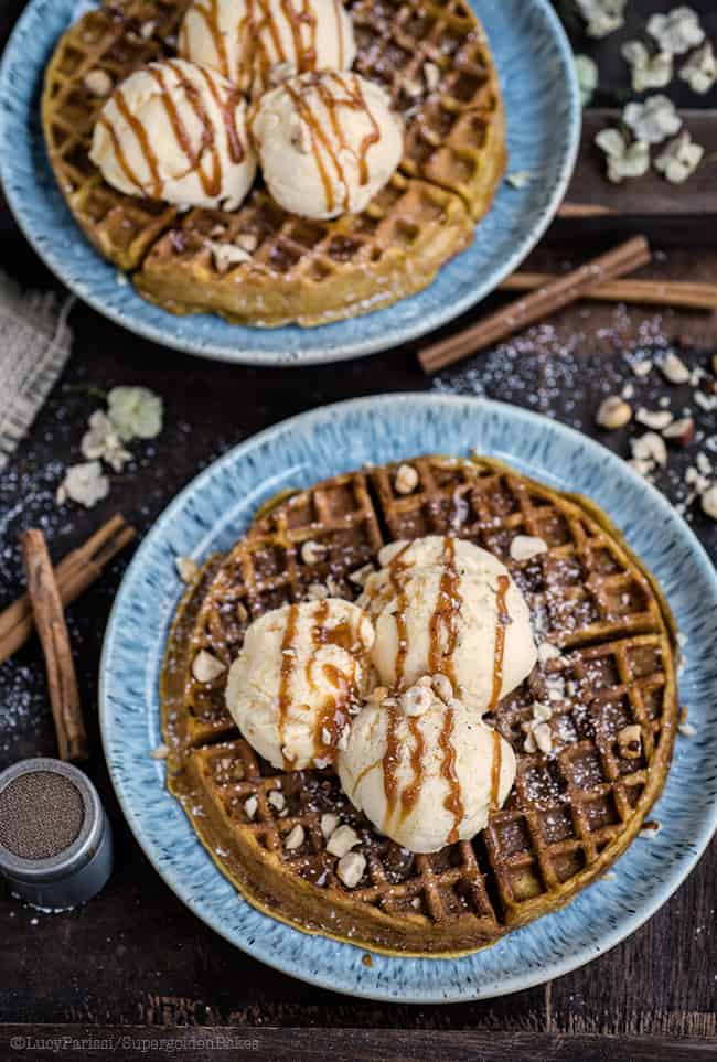 Two plates of pumpkin waffles served with ice cream