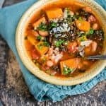 This hearty vegetarian slow cooker squash, bean, and kale stew is the perfect winter warmer.