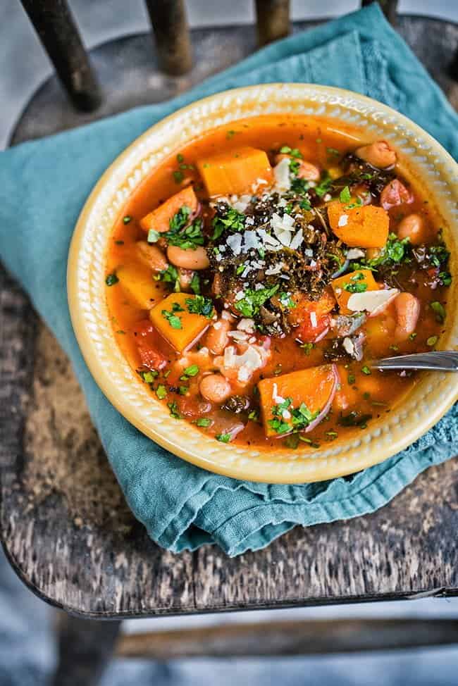 This hearty vegetarian slow cooker squash, bean, and kale stew is the perfect winter warmer. 