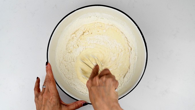Mixing batter for  pancakes in a bowl