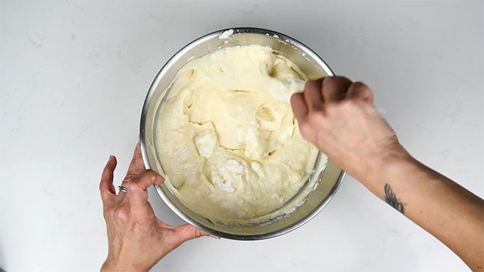folding whisked eggs into cheesecake filling