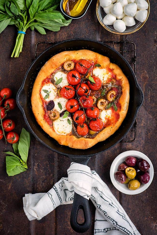 Puttanesca skillet pizza with olives, anchovies and mozzarella