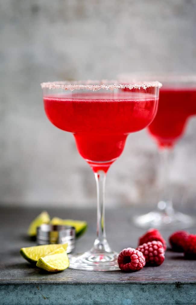 Two glasses with raspberry margarita cocktails