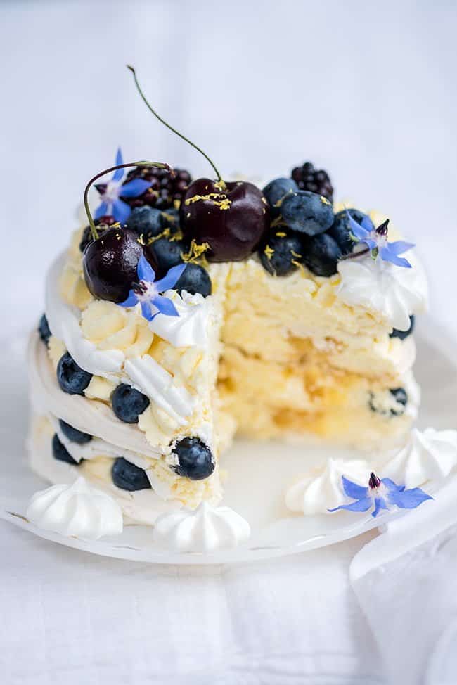 Meringue Stack Cake with Whipped Cream, Lemon Curd, and Berries