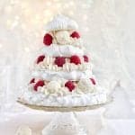 Meringue Christmas cake with whipped coconut cream, raspberries and white chocolate truffles