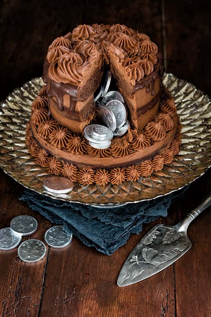 A towering festive chocolate pinata cake with chocolate, chestnut and mascarpone frosting and hidden silver coins to bring good luck to the new year!