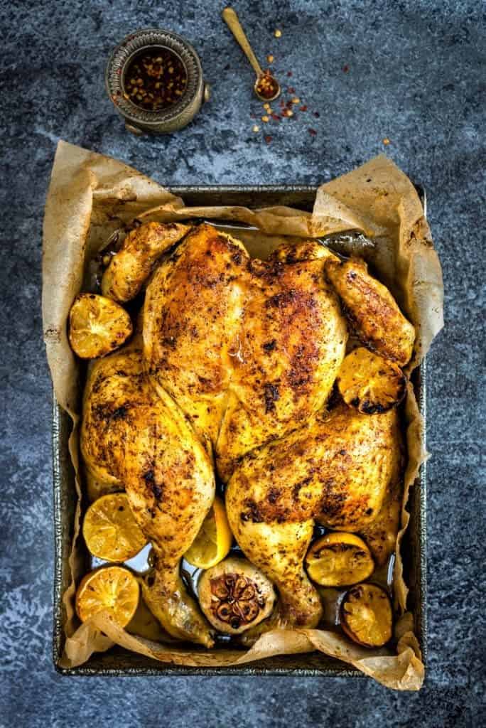 Spicy roast chicken on a baking tray
