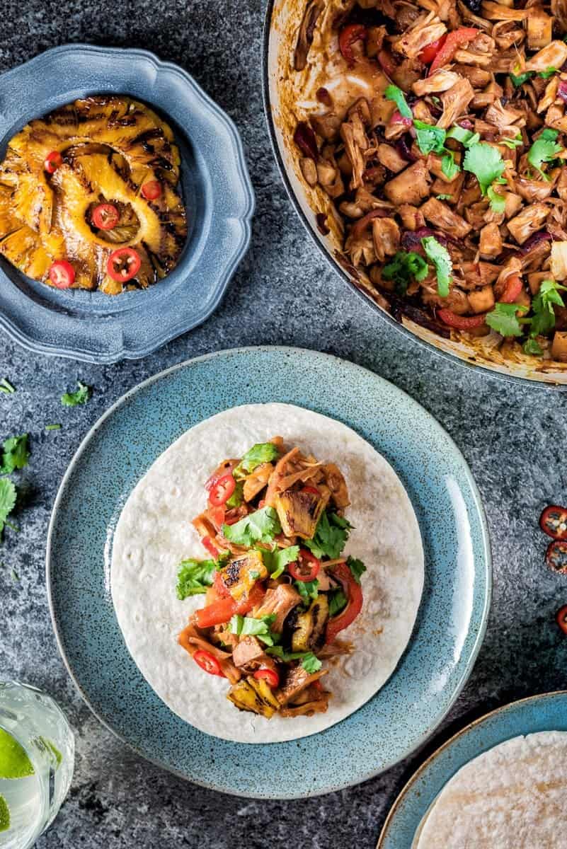 Plate of vegan jackfruit tacos with grilled pineapple
