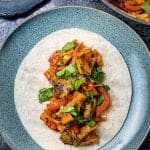 You won't believe these tacos are vegan! Jackfruit replaces pulled pork seamlessly in these spicy tacos served with grilled pineapple.