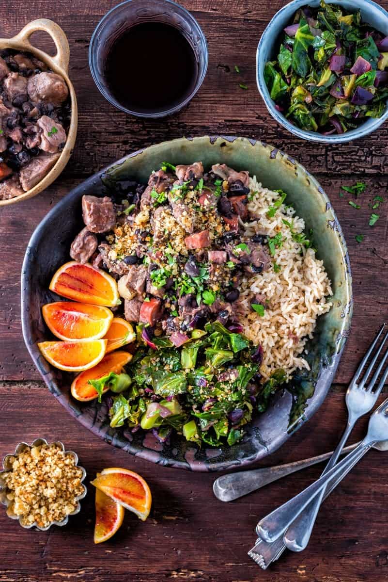 Slow cooker Brazilian feijoada – rich pork stew with black beans served with spring greens and rice