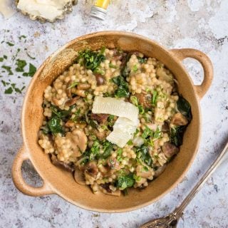 Cheat’s risotto with giant couscous, wild mushrooms, chestnuts, spinach and Parmesan. This easy and filling recipe is ready in under 30 minutes.