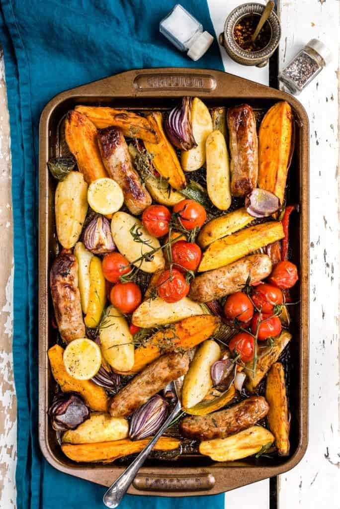 Overhead view of sausage, potato and pepper traybake – a colourful and mega tasty meal that is sure to become a family favourite.