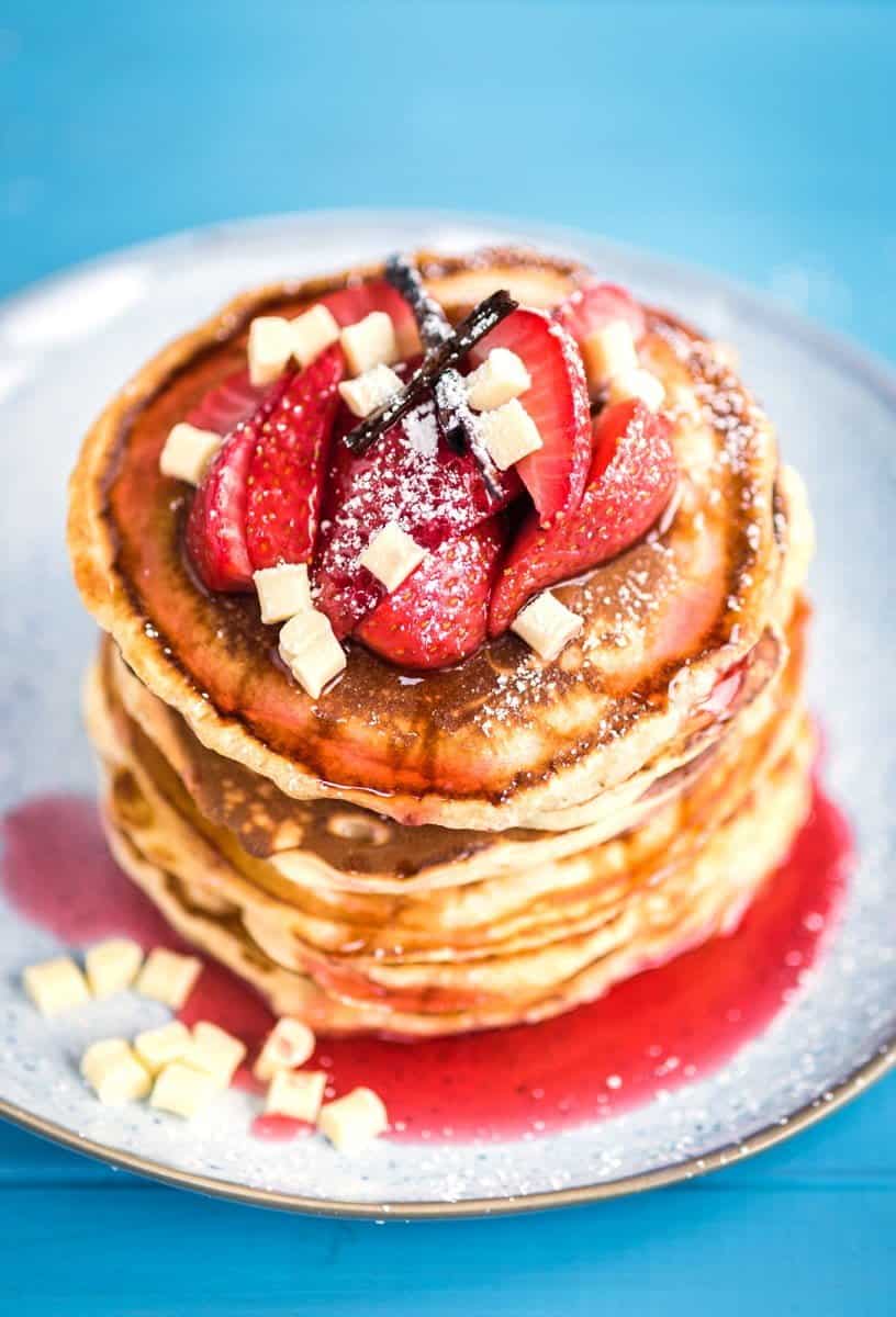Fluffy white chocolate pancakes with roasted strawberries – a special indulgent treat for Pancake Day!