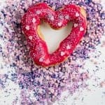 Surprise your Valentine with these delicious heart-shaped chocolate eclairs with vibrant berry glaze and fairy sprinkles!