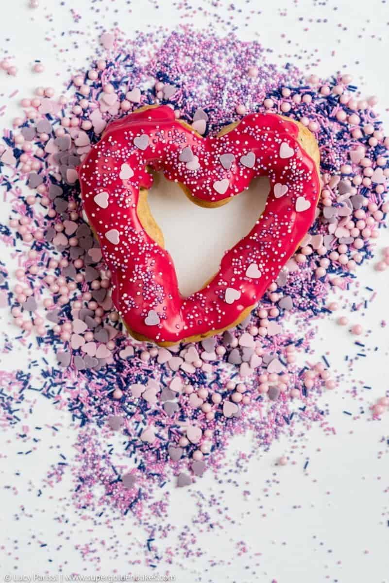 Surprise your Valentine with these delicious heart-shaped chocolate eclairs with vibrant berry glaze and fairy sprinkles!