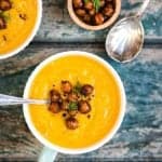 This vegan spiced carrot, parsnip and chickpea soup is simple to make but anything but ordinary! Top with crispy spicy chickpeas for a satisfying lunch.