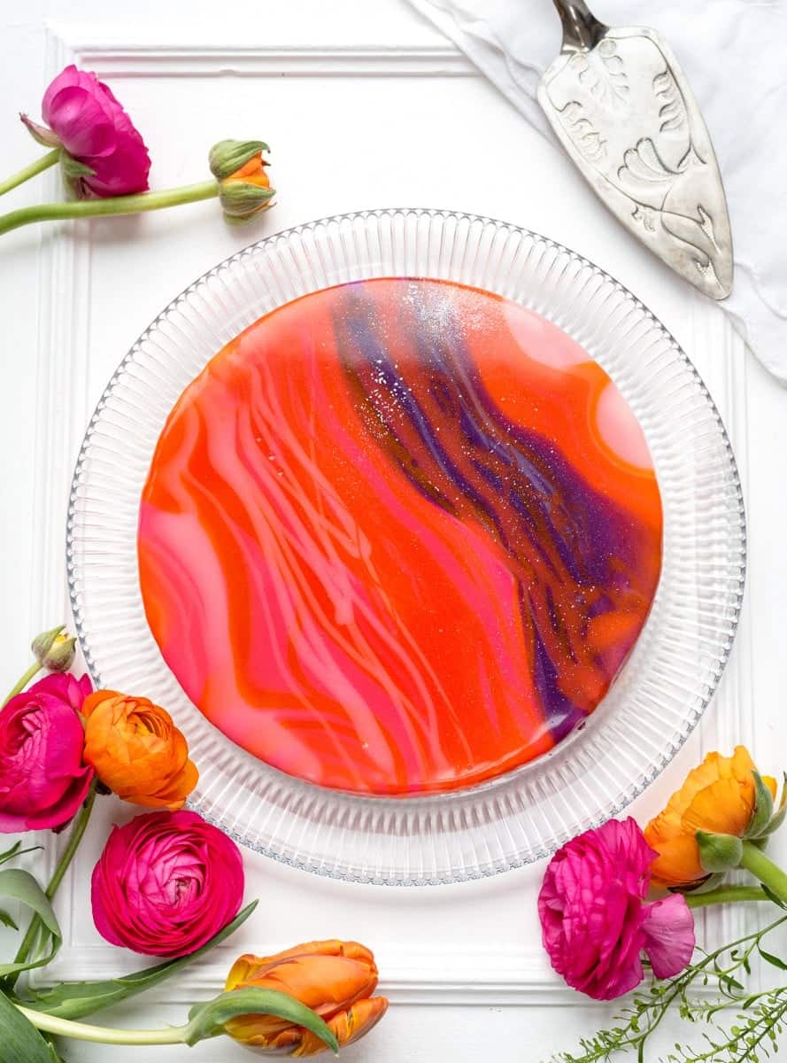 white chocolate cheesecake covered with colourful mirror glaze