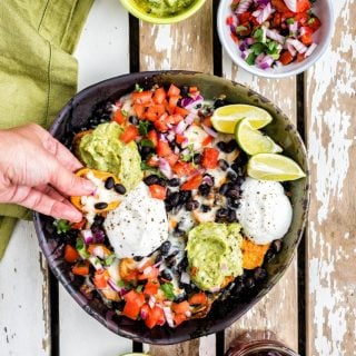 Fully loaded vegetarian sweet potato nachos with guacamole and salsa