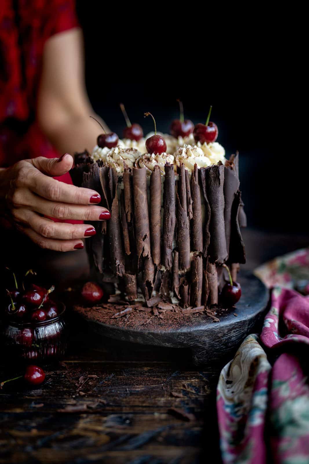 Black Forest Gâteau decorated with chocolate curls and fresh cherries