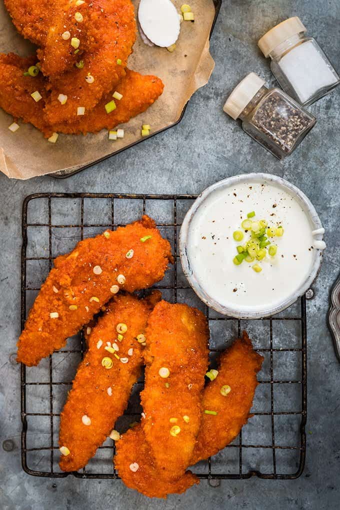 Oven-baked Buffalo chicken fingers with feta yoghurt dip – spicy, tender, delicious and meant for sharing!