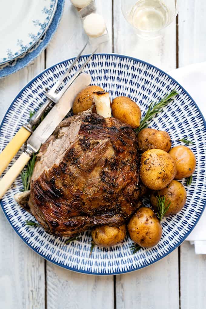 Platter of Greek roast lamb with potatoes and rosemary