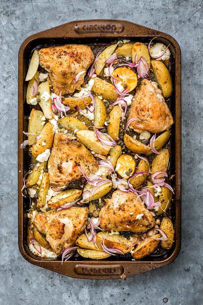 Greek sheet pan chicken with potatoes, capers and feta cheese – cooks in 30 minutes and simply packed with flavour! Serve with a crisp green salad and some crusty bread.