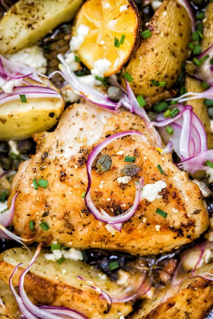 Greek sheet pan chicken with potatoes, capers and feta cheese – cooks in 30 minutes and simply packed with flavour! Serve with a crisp green salad and some crusty bread.
