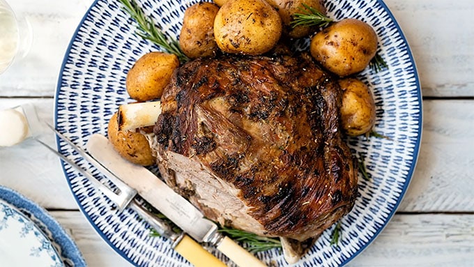 Leg of lamb on a platter with slice carved 