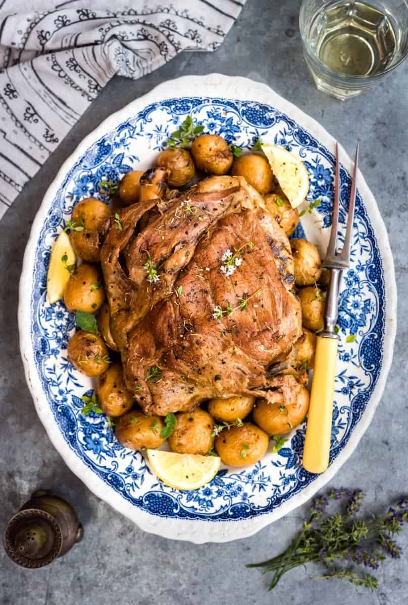 Slow cooked Greek Lamb kleftiko served on a platter with potatoes