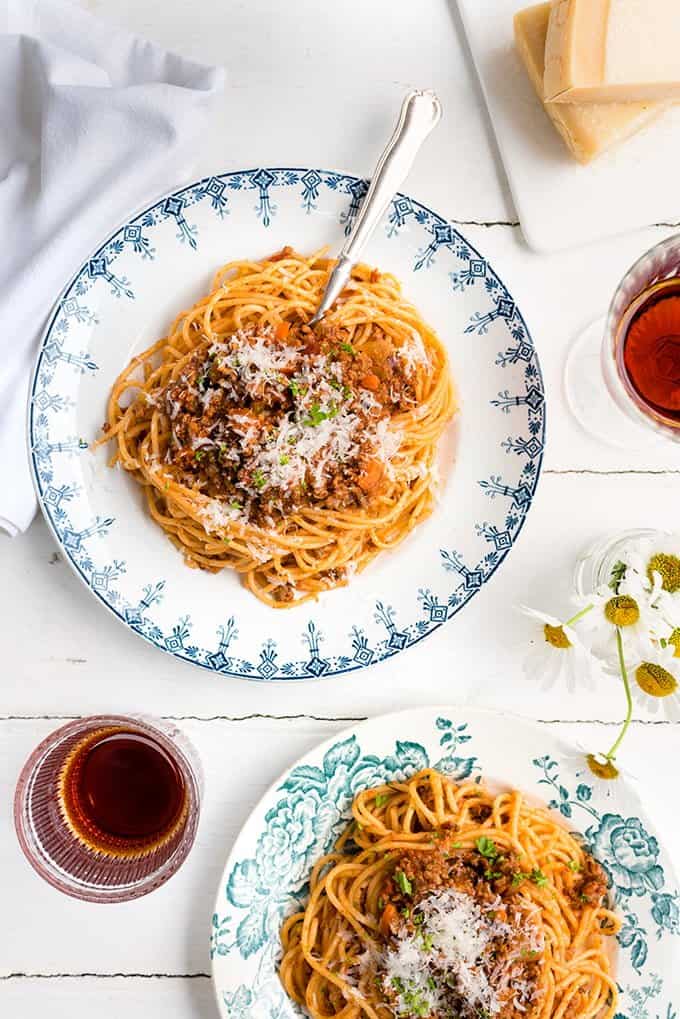 two servings of spaghetti Bolognese with grated parmesan