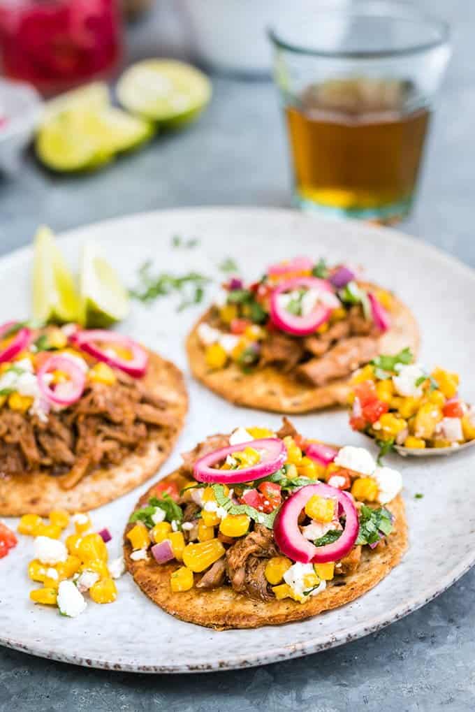 Bourbon and coke pulled pork tostadas with quick sweetcorn salsa and pickled onions