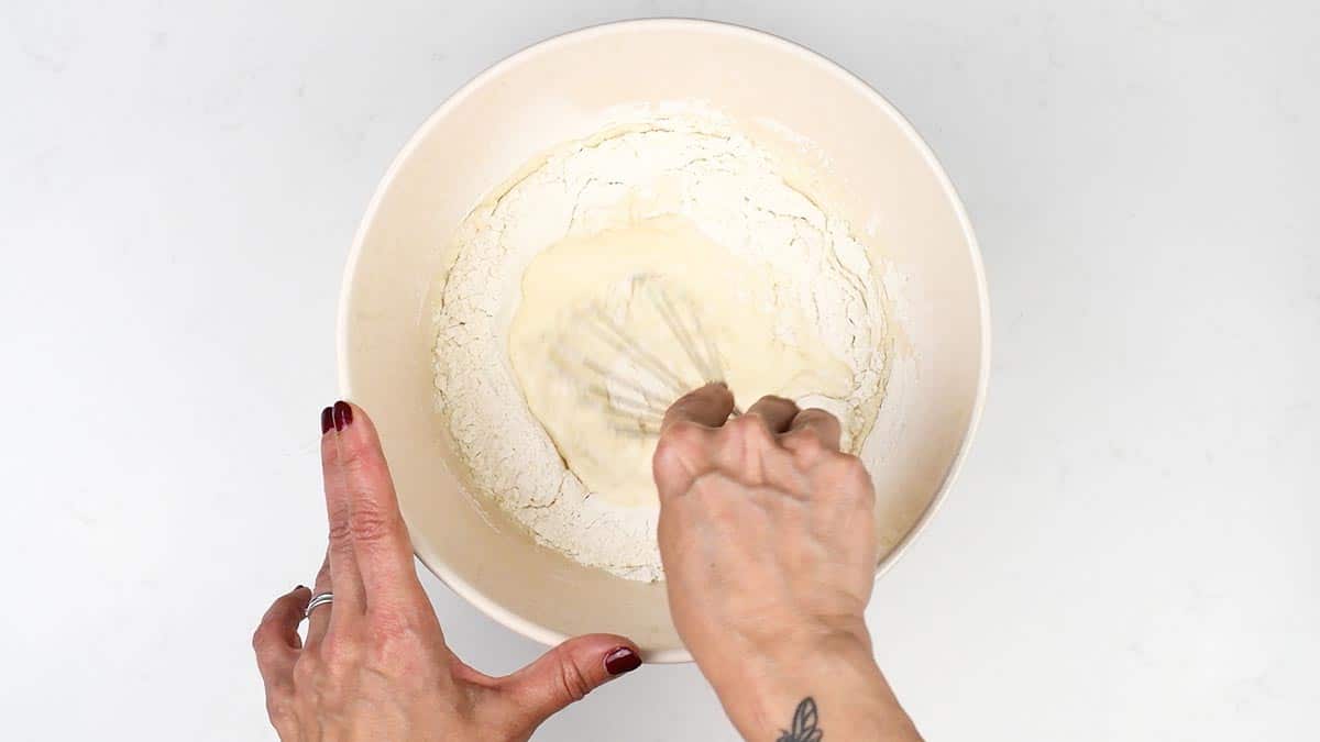 stirring Yorkshire pudding batter with a balloon whisk