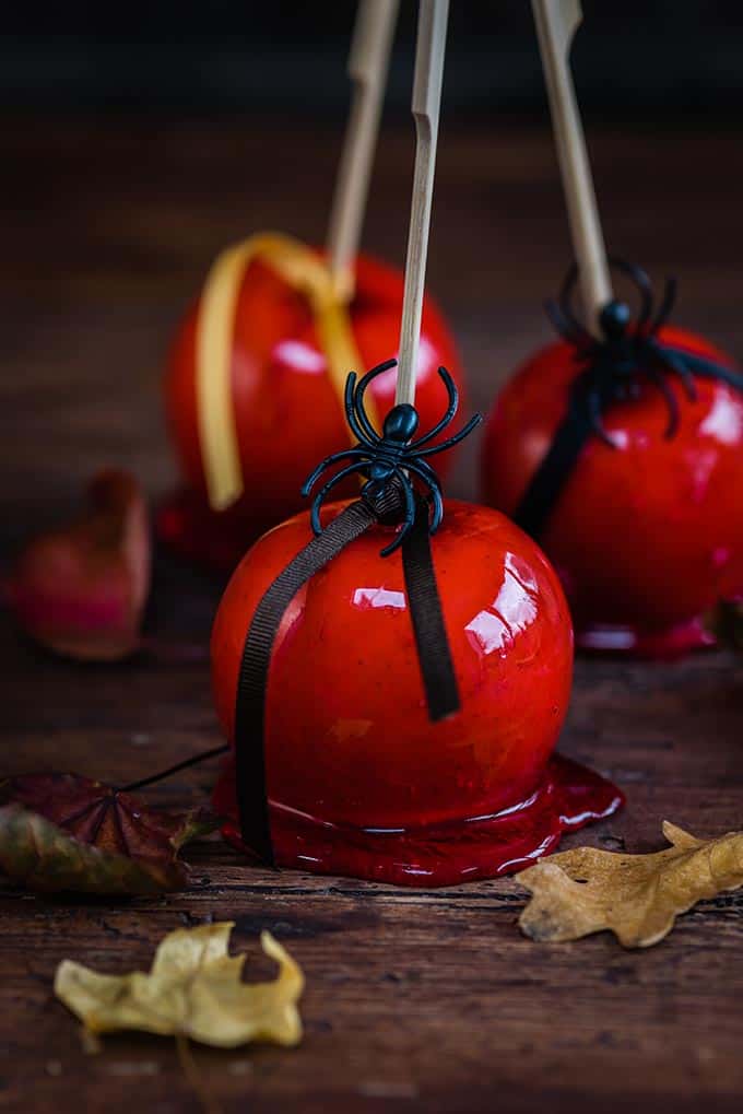 Red candy apples with halloween decorations