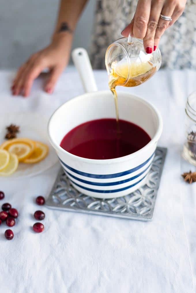 This virgin mulled cranberry punch is perfect for the holidays! Made with Ocean Spray Wholeberry™ Cranberry plus citrus and seasonal spices, it is perfect enjoyed warm whether you are the designated driver or not! #nonalcoholic #punch #holidaydrink #virginpunch #mulledwine #cranberrypunch #christmas