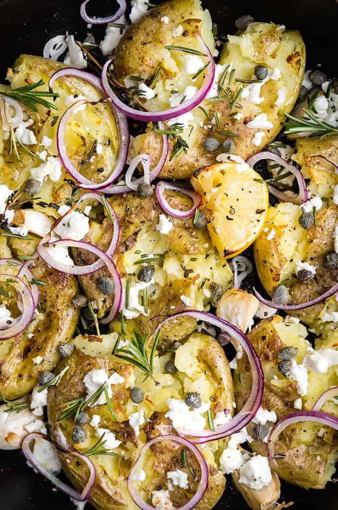 Greek smashed potatoes with feta cheese, rosemary, garlic, capers and onions